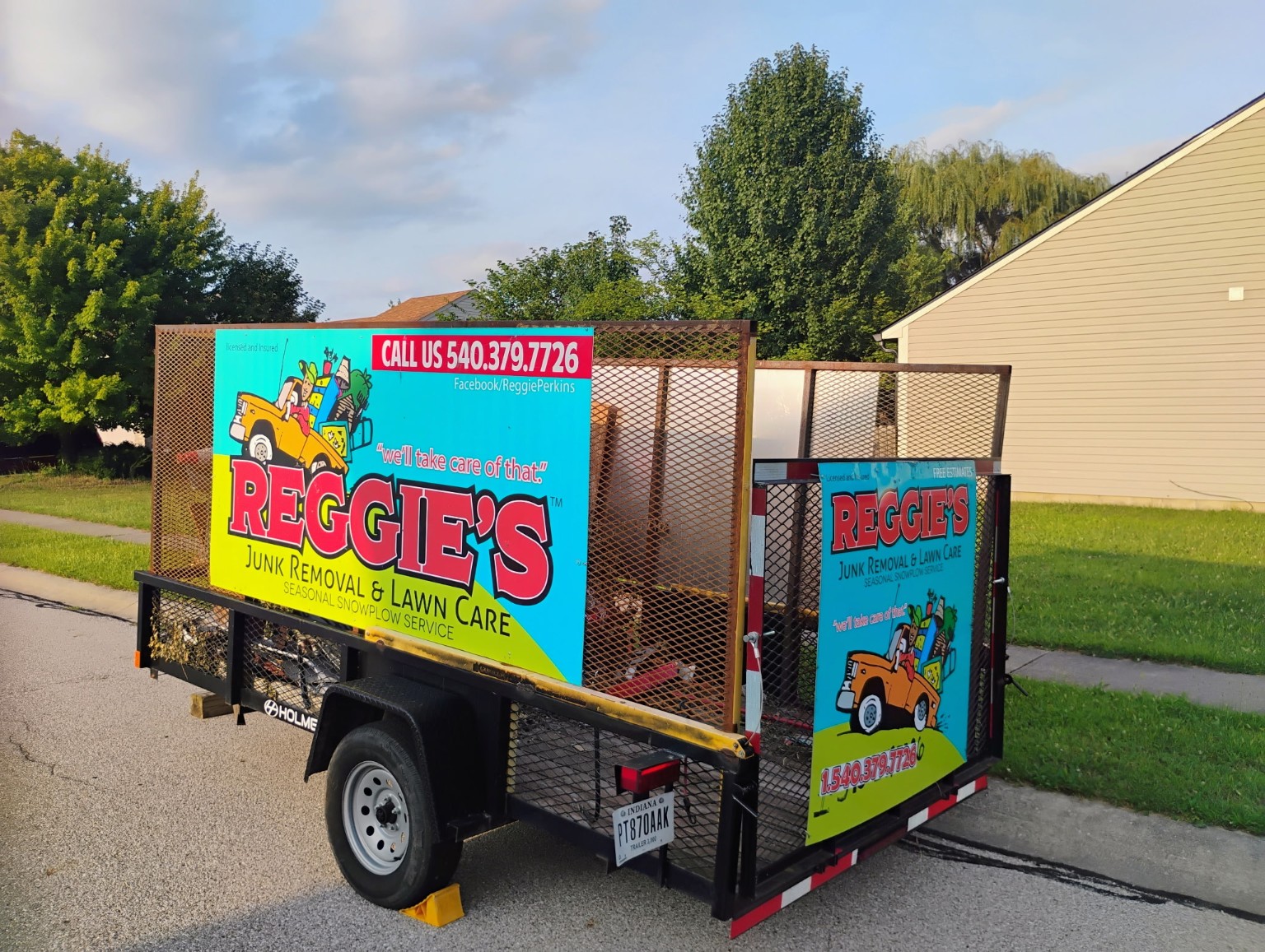 Reggie's complete work trailer with bright business signs